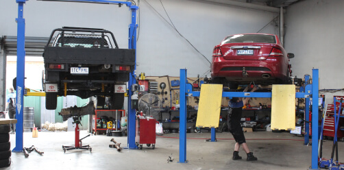 servicing two customers cars on hoists in our workshop